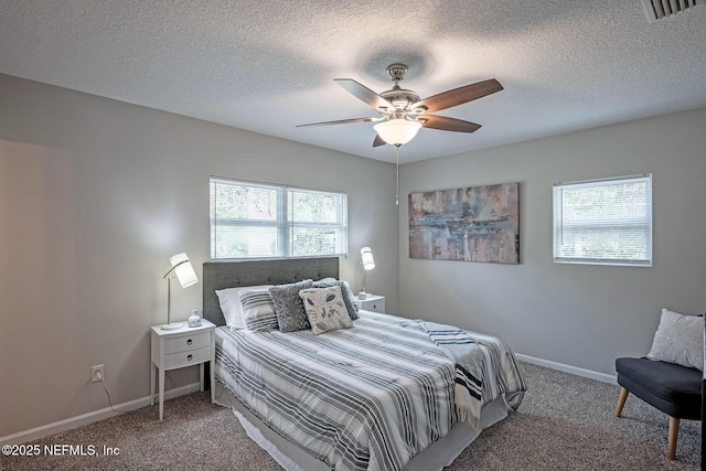 bedroom featuring a textured ceiling, carpet floors, and ceiling fan