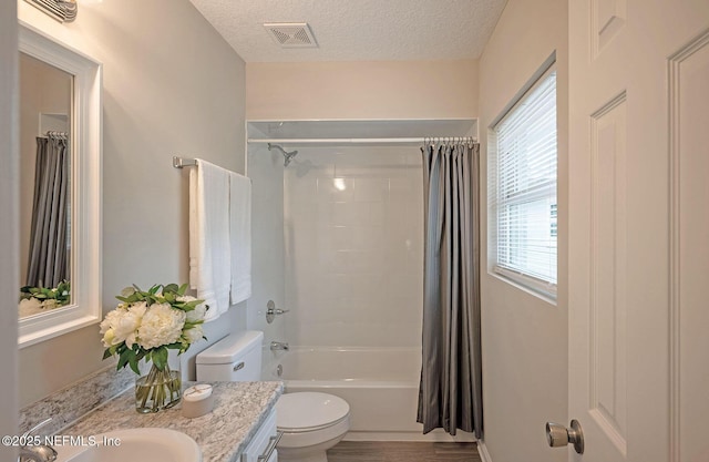 full bathroom featuring toilet, a textured ceiling, hardwood / wood-style flooring, vanity, and shower / bath combination with curtain