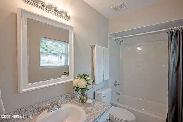 full bathroom with shower / bathtub combination with curtain, vanity, toilet, and a textured ceiling