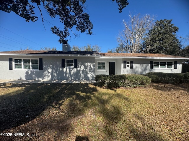 single story home featuring a front yard