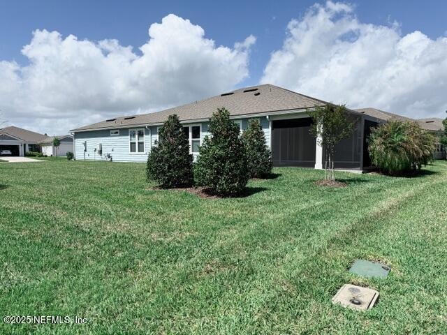 back of property with a lawn