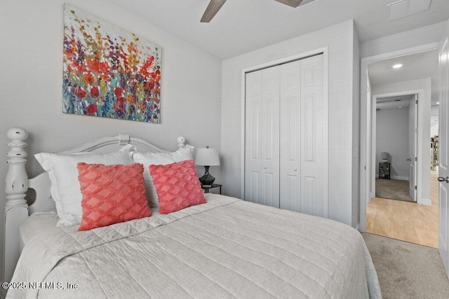 carpeted bedroom featuring ceiling fan and a closet