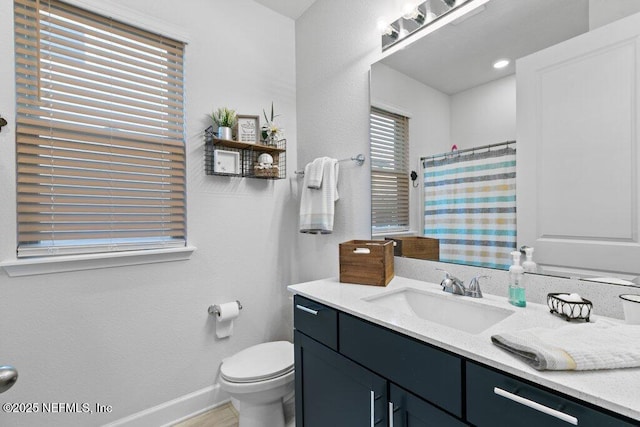 bathroom featuring vanity, toilet, and a shower with shower curtain