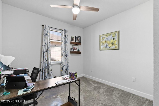 carpeted home office featuring ceiling fan