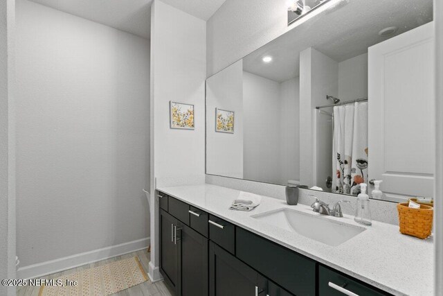 bathroom with vanity and a shower with shower curtain