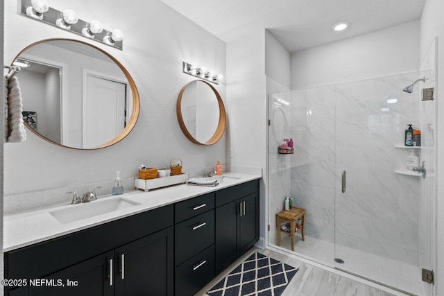 bathroom with a shower with door and vanity