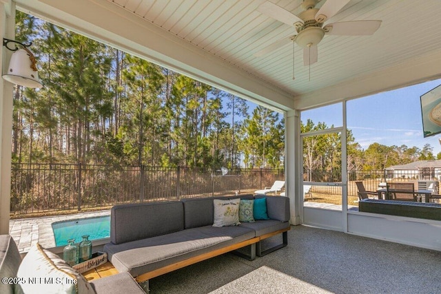 sunroom / solarium featuring ceiling fan and a wealth of natural light