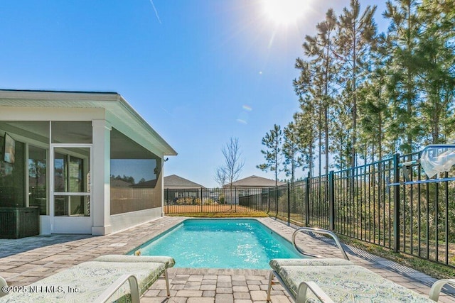 view of pool with a patio area and a sunroom