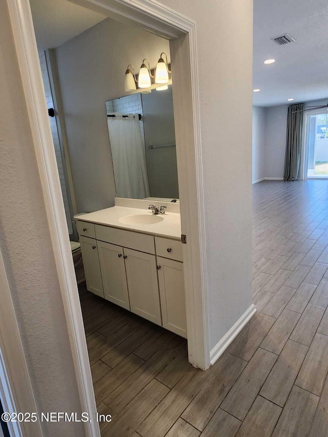 bathroom featuring vanity and toilet