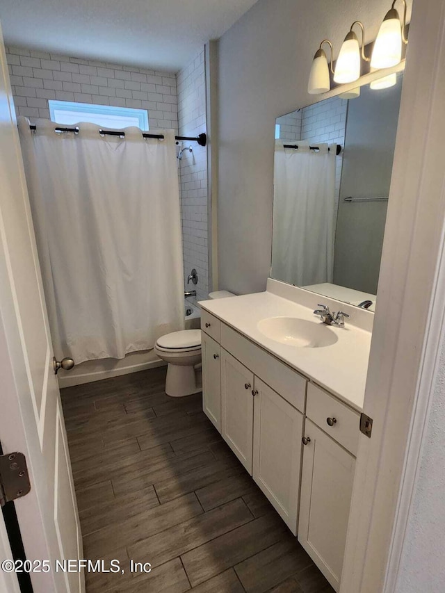 full bathroom featuring vanity, toilet, and shower / tub combo