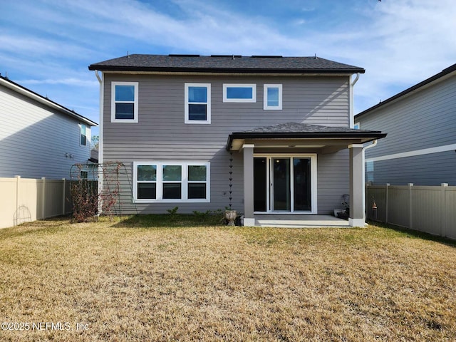 back of property featuring a patio area and a lawn