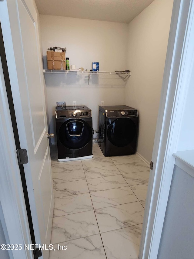 laundry room with washing machine and dryer