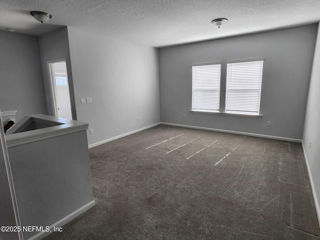 carpeted spare room featuring a textured ceiling