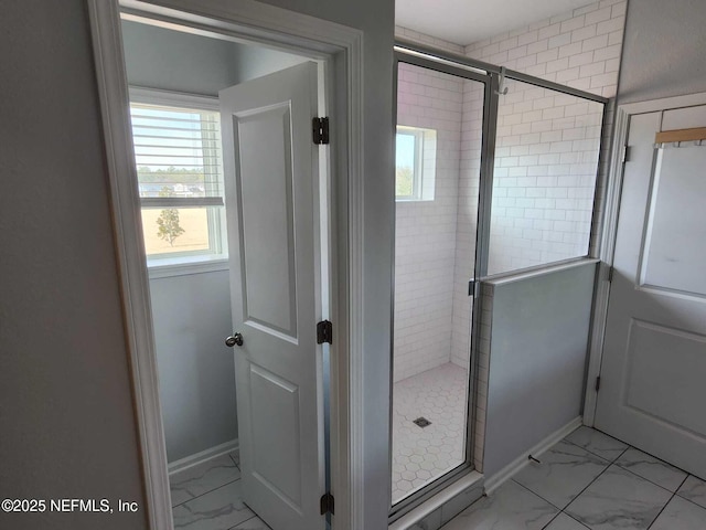 bathroom featuring a shower with shower door