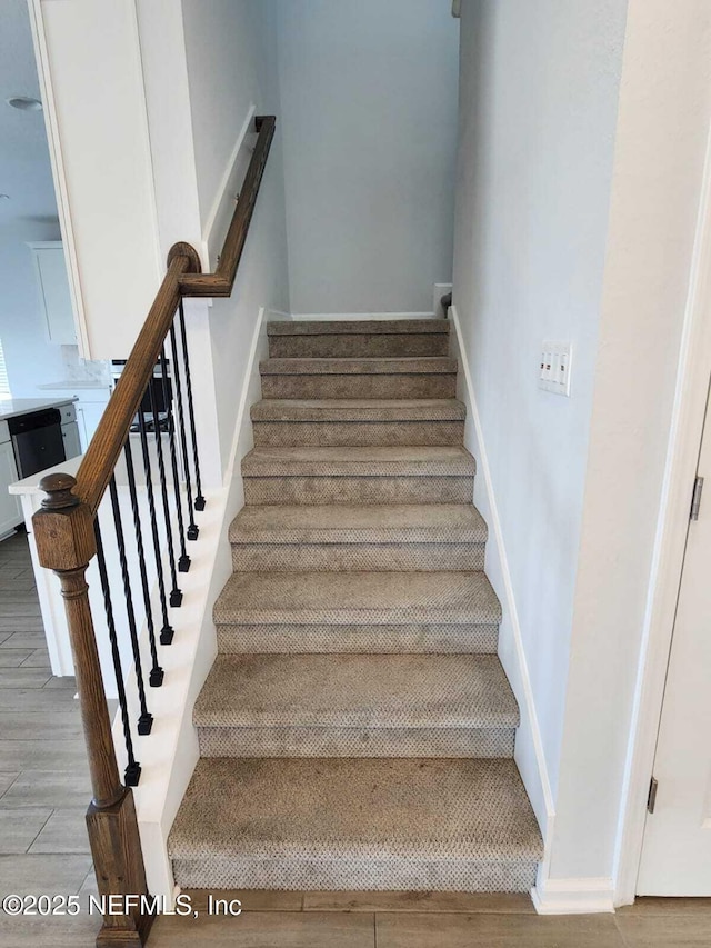 stairs with wood-type flooring