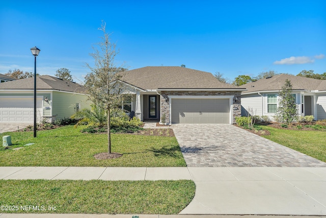 single story home featuring a garage and a front yard