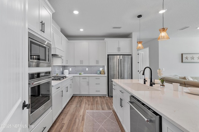 kitchen featuring white cabinetry, appliances with stainless steel finishes, and sink