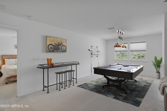 playroom featuring billiards, light colored carpet, and a textured ceiling