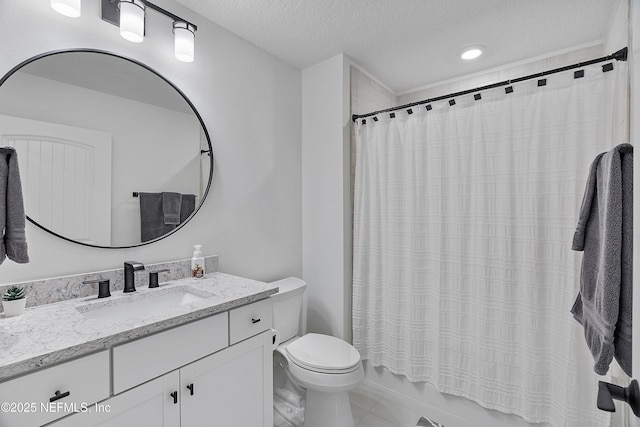 full bathroom with vanity, shower / tub combo, toilet, and a textured ceiling