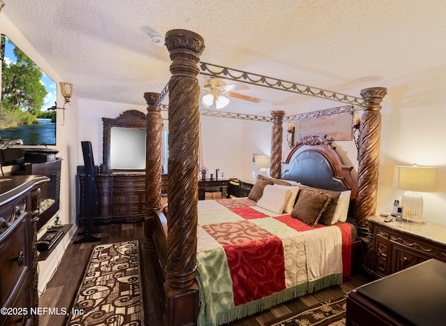 bedroom with dark wood-type flooring and a textured ceiling