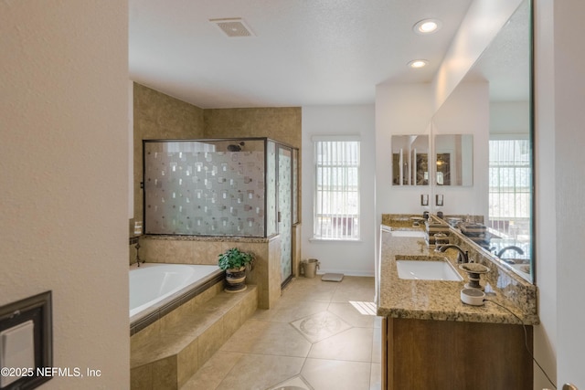 bathroom featuring tile patterned flooring, vanity, and separate shower and tub