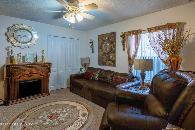 living room featuring light carpet, ceiling fan, and a textured ceiling