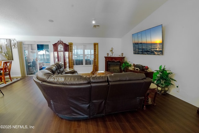 living room featuring hardwood / wood-style flooring and vaulted ceiling