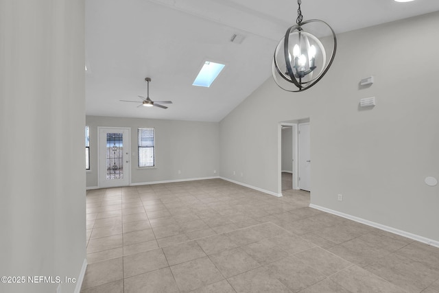 unfurnished living room with light tile patterned floors, ceiling fan with notable chandelier, high vaulted ceiling, and a skylight