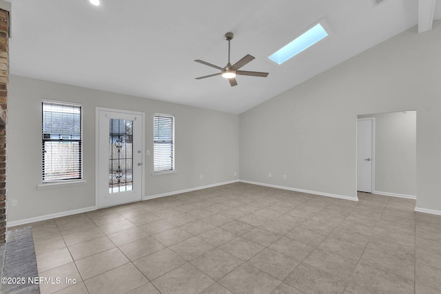 empty room featuring a skylight, high vaulted ceiling, and ceiling fan