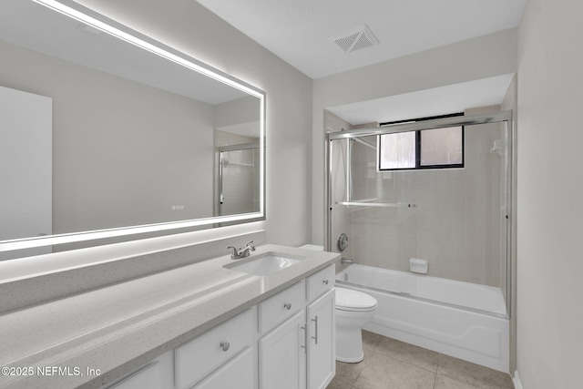 full bathroom with enclosed tub / shower combo, vanity, toilet, and tile patterned flooring