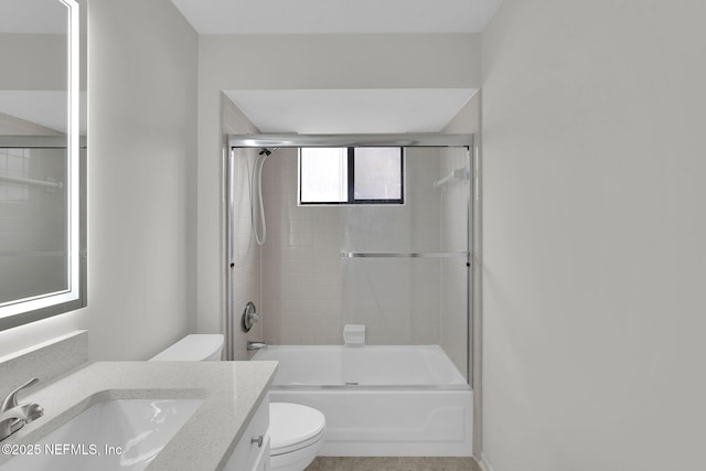 full bathroom with toilet, vanity, and bath / shower combo with glass door