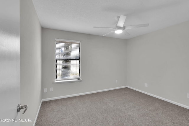 carpeted empty room with ceiling fan and a textured ceiling