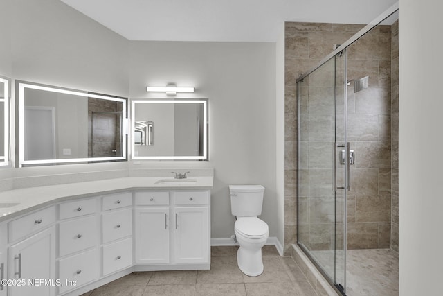 bathroom with vanity, tile patterned floors, toilet, and walk in shower