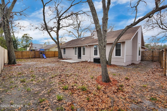 rear view of property with a playground and a patio