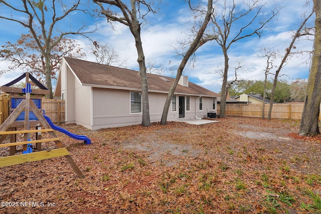 rear view of house with a patio and a playground