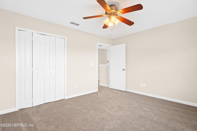 unfurnished bedroom featuring carpet floors, a closet, and ceiling fan