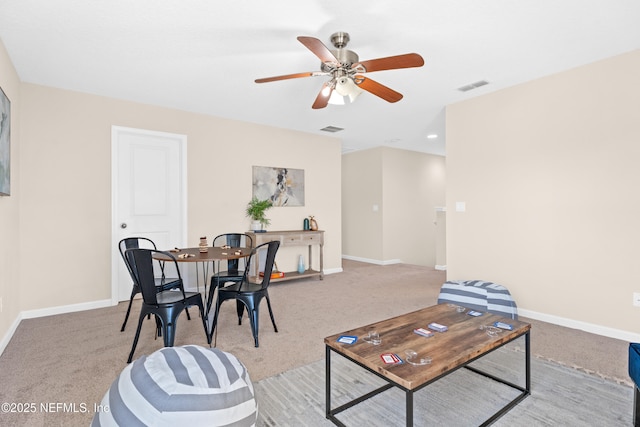 carpeted living room featuring ceiling fan