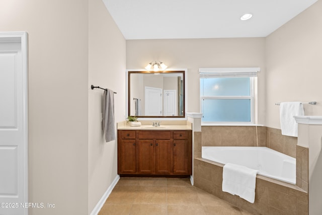 bathroom with vanity, tiled bath, and tile patterned floors