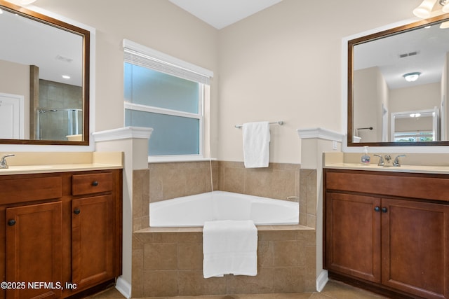 bathroom with tile patterned floors, vanity, and separate shower and tub