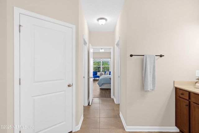 bathroom with vanity, tile patterned floors, and a textured ceiling