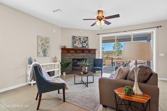 living room with light tile patterned flooring, ceiling fan, and a fireplace