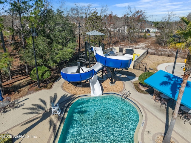 view of swimming pool with a patio area and a water slide