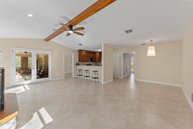 unfurnished living room featuring vaulted ceiling with beams, light tile patterned floors, ceiling fan, and french doors