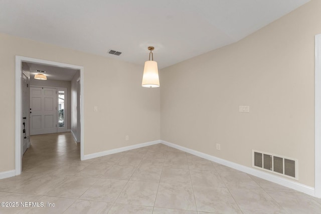 spare room featuring light tile patterned floors