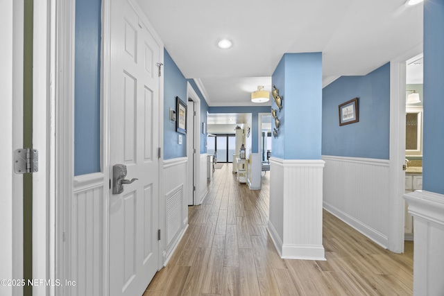 hallway with light hardwood / wood-style flooring