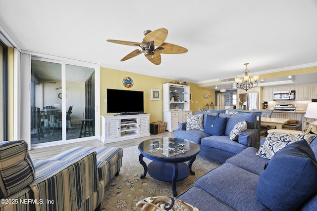 living room featuring ornamental molding, ceiling fan with notable chandelier, and light wood-type flooring