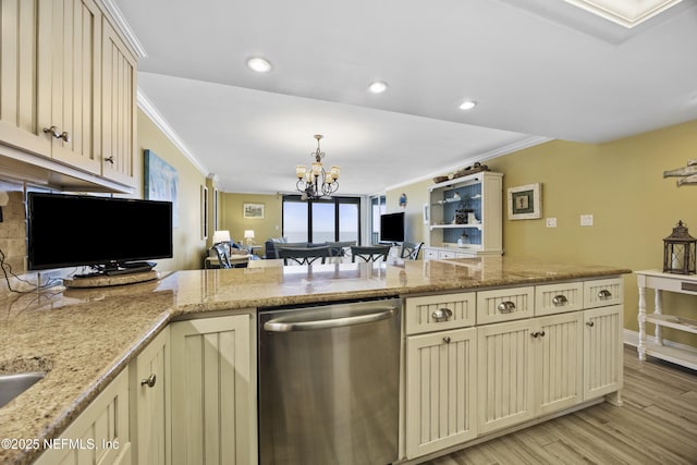 kitchen featuring kitchen peninsula, ornamental molding, cream cabinetry, and dishwasher