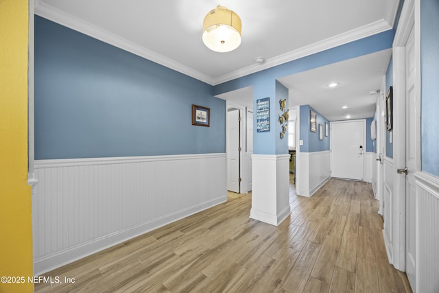 interior space featuring ornamental molding and light hardwood / wood-style floors