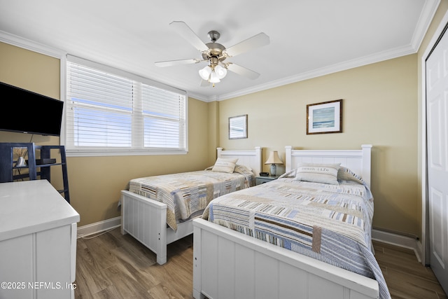 bedroom with crown molding, ceiling fan, and hardwood / wood-style floors