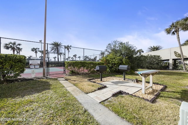 surrounding community with a yard and tennis court